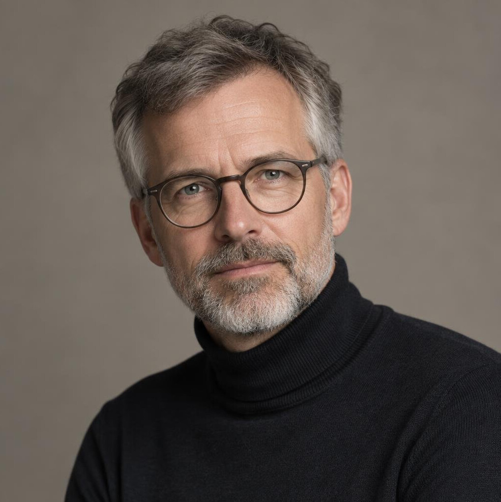 Studio portrait of a man researcher with beard and glasses