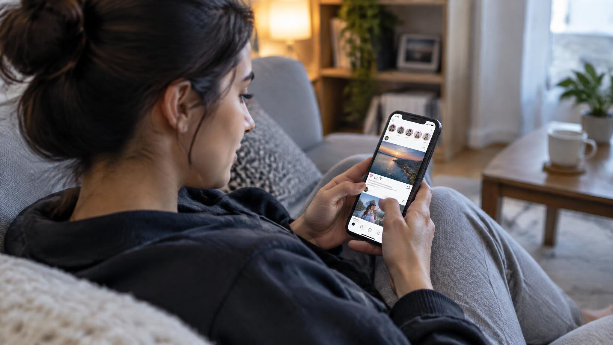 person scrolling phone at home