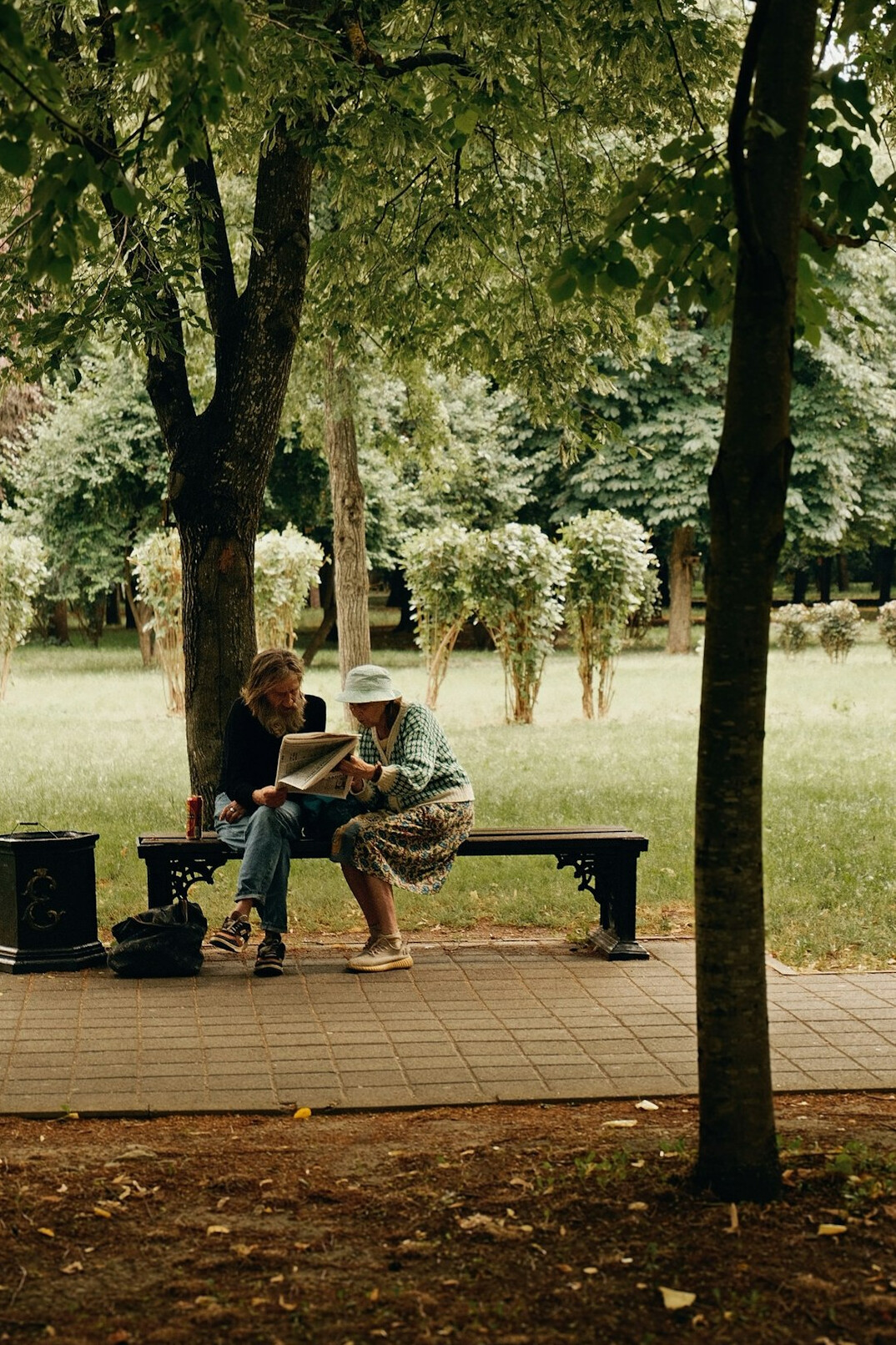 person reading newspaper outdoors